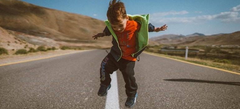 A kid jumping on the street