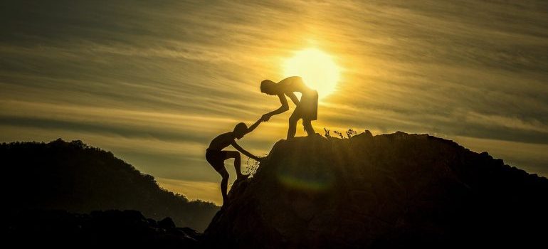 A boy helping another boy