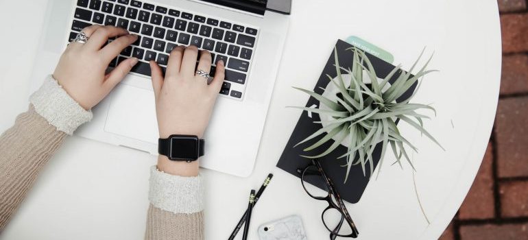A person typing on a laptop