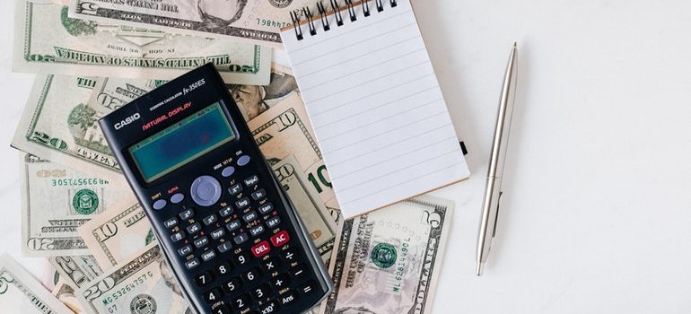 Calculator and money on a table.